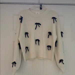 Elegant Cream Sweater with Black Bow Details